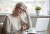 A woman sitting looking lonely at a computer
