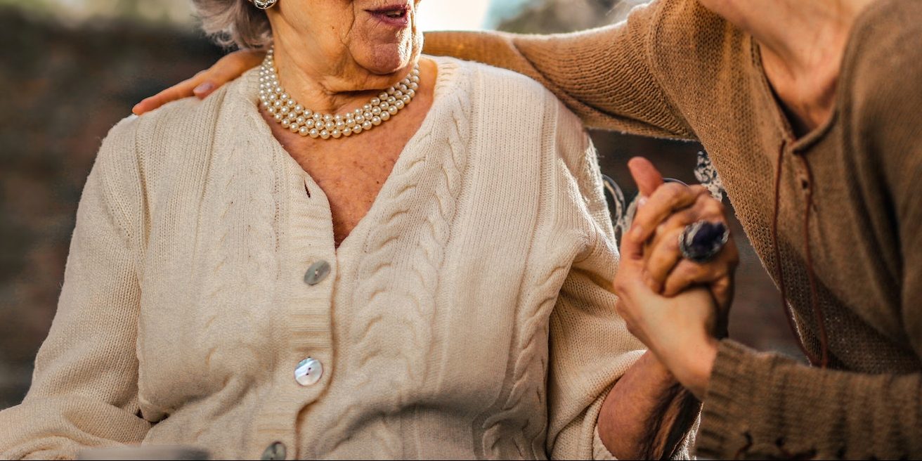 An elderly person speaking with their carent 