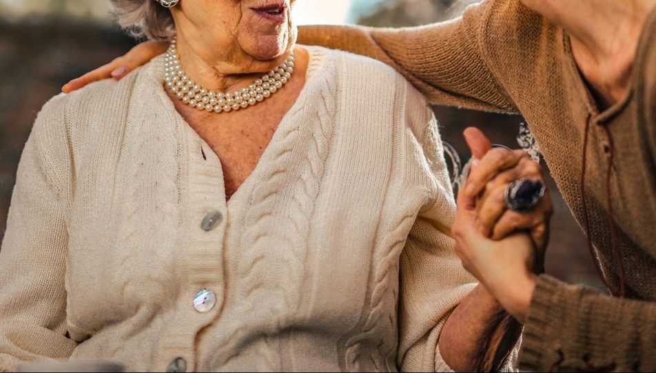 An elderly person speaking with their carent 