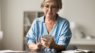 Carent accessing digital support services through her mobile phone