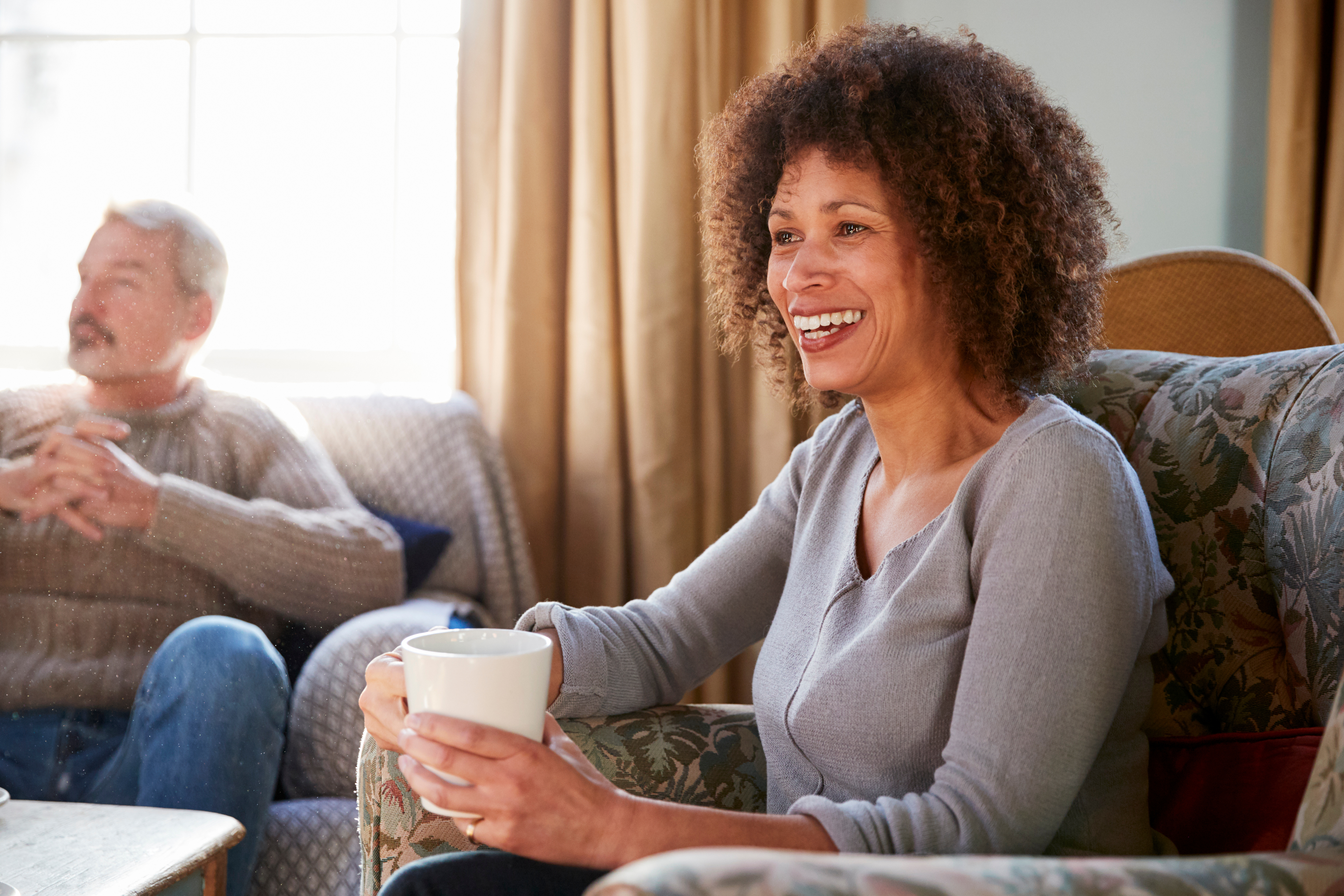 A woman looking after her elderly parents sharing a coffee and telling her story 