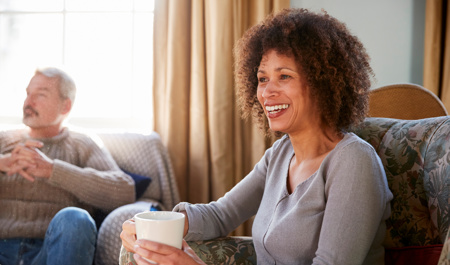 A woman looking after her elderly parents sharing a coffee and telling her story 