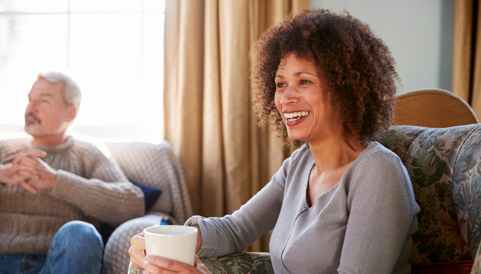 A woman looking after her elderly parents sharing a coffee and telling her story 