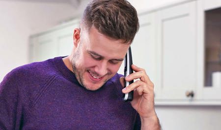 a carent using the phone arranging discussing with BT the digital switchover on behalf of their elderly parent.
