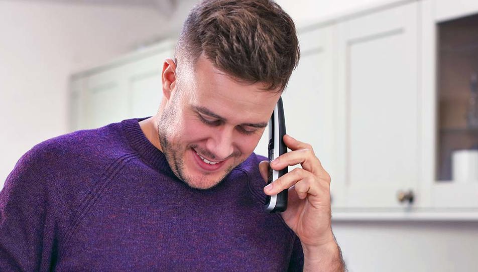a carent using the phone arranging discussing with BT the digital switchover on behalf of their elderly parent.