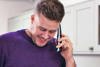 a carent using the phone arranging discussing with BT the digital switchover on behalf of their elderly parent.