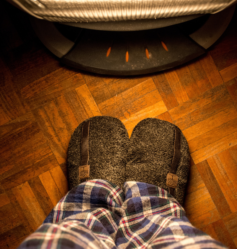 Close-up of an older adult wearing warm, cushioned slippers indoors – comfortable slippers help elderly parents stay steady on their feet while keeping warm, especially on hard flooring.