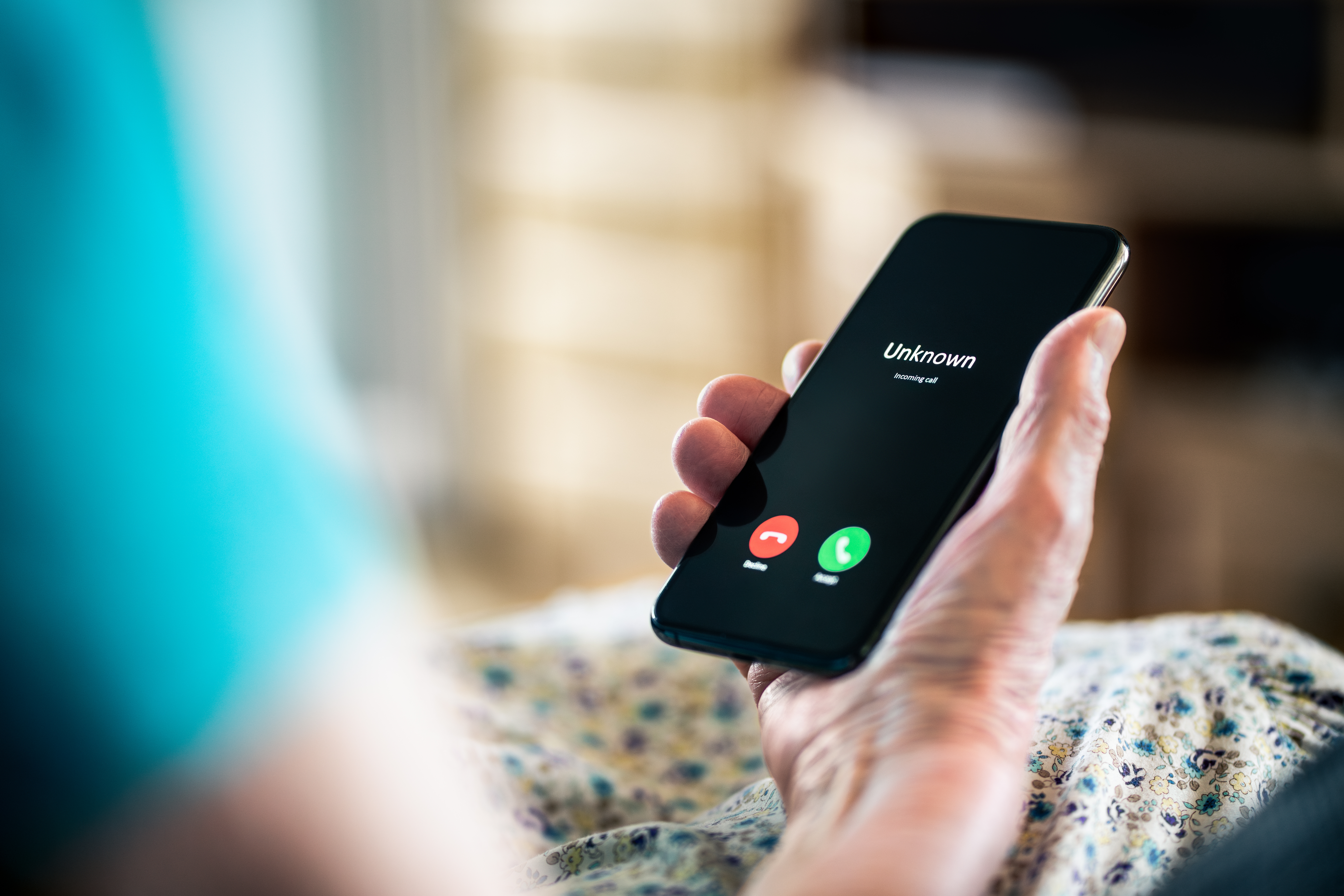 Smart phone with unknown caller ID. Used to represent the danger of scam calls.