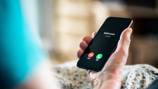 Smart phone with unknown caller ID. Used to represent the danger of scam calls.