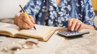 Middle-aged woman calculating finances