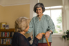 Carent providing support for their elderly parent with worry on their face